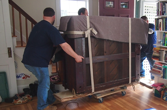 piano moving across house